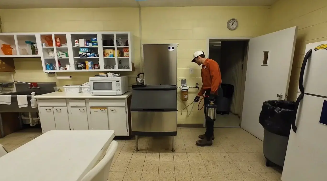 Treating along kitchen walls and appliances for cockroaches